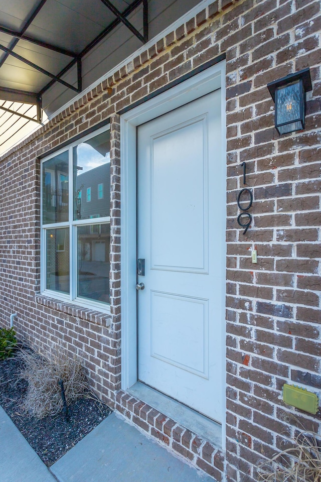 entrance to property with brick siding