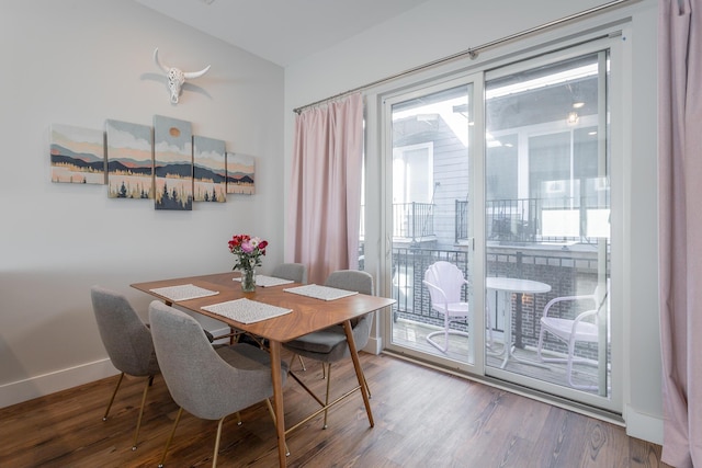 dining room with baseboards, wood finished floors, and a healthy amount of sunlight