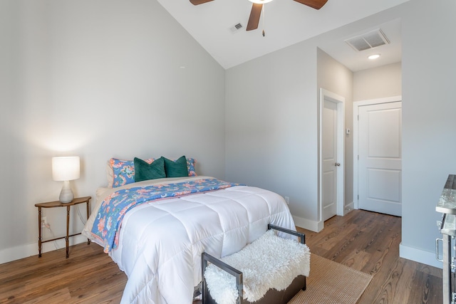 bedroom featuring a ceiling fan, wood finished floors, visible vents, and baseboards