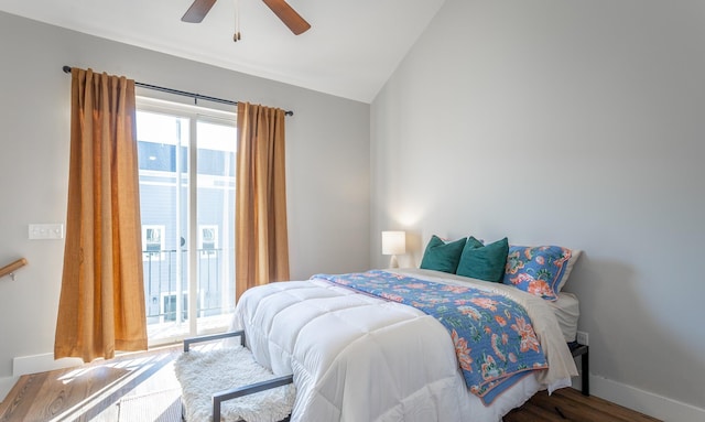 bedroom featuring baseboards, a ceiling fan, wood finished floors, access to outside, and vaulted ceiling