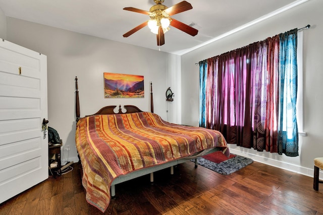 bedroom with dark wood-style floors, visible vents, and a ceiling fan