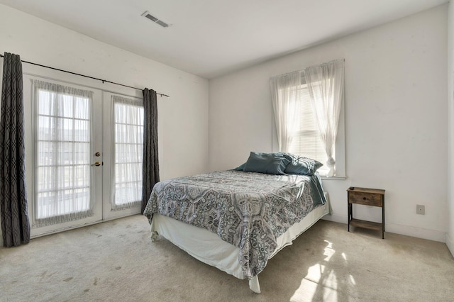 bedroom with carpet floors, french doors, visible vents, access to outside, and baseboards