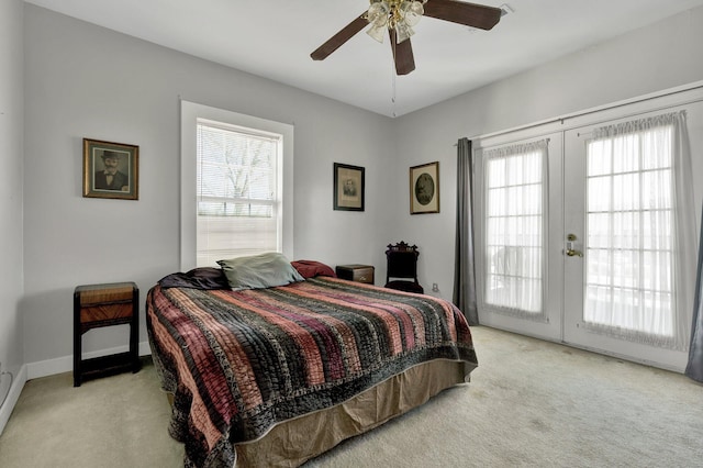 bedroom with access to outside, french doors, light colored carpet, and ceiling fan