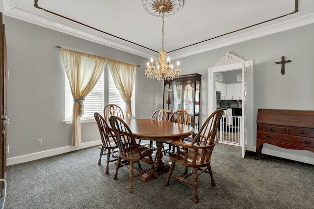 dining space with a chandelier, dark colored carpet, ornamental molding, and baseboards