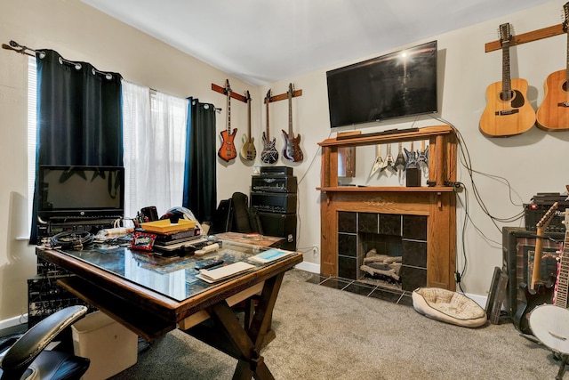 carpeted dining space with a tile fireplace and baseboards