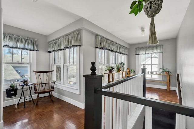 corridor with an upstairs landing and baseboards