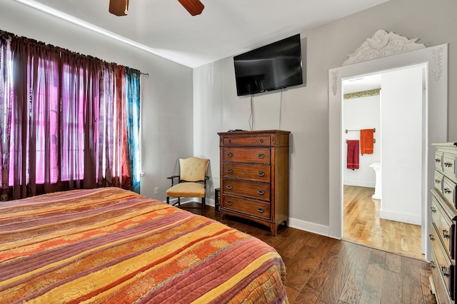 bedroom featuring a ceiling fan, baseboards, and dark wood-type flooring