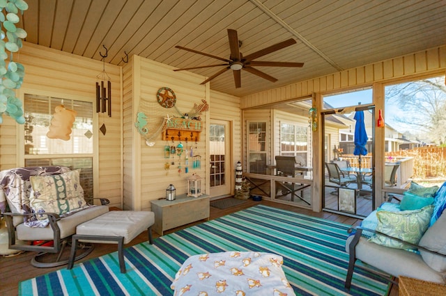 sunroom / solarium with wood ceiling and a ceiling fan