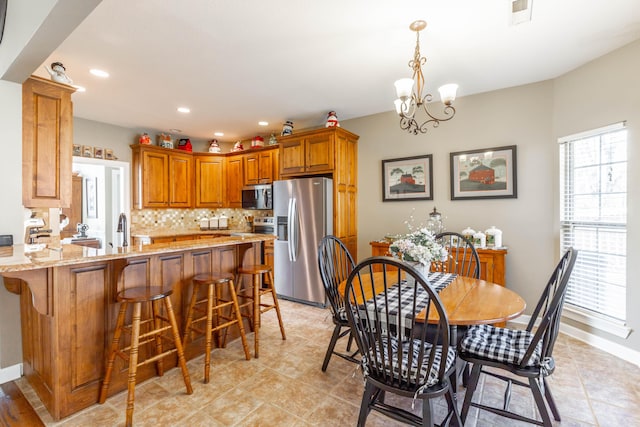 dining space featuring baseboards, visible vents, a notable chandelier, and recessed lighting