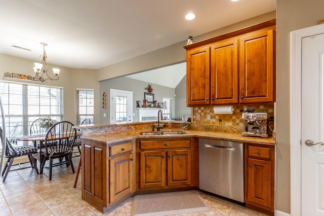 kitchen with a sink, visible vents, brown cabinetry, and dishwasher