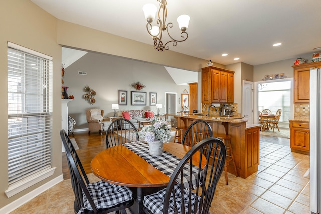 dining area with light tile patterned floors, recessed lighting, visible vents, baseboards, and an inviting chandelier