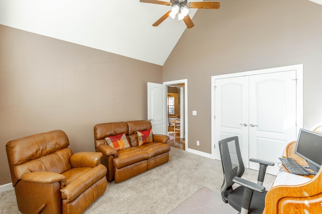 carpeted home office featuring ceiling fan, high vaulted ceiling, and baseboards