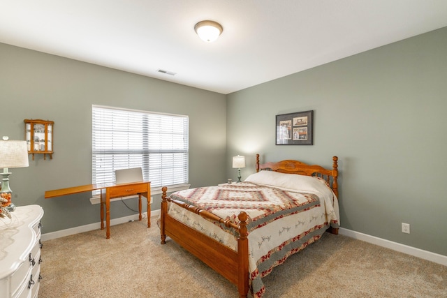 bedroom with light carpet, visible vents, and baseboards