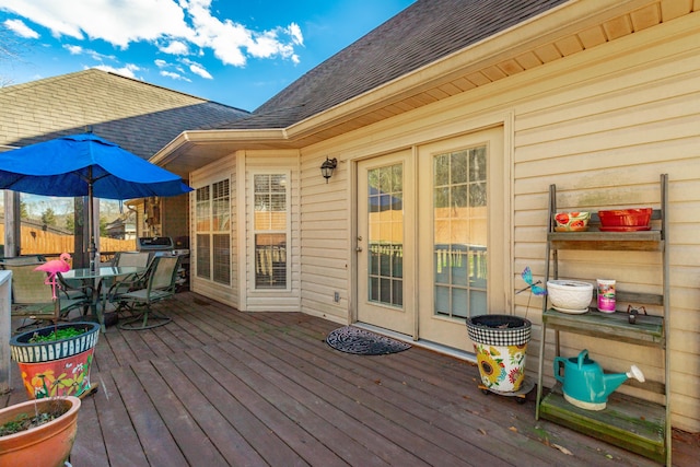 wooden terrace featuring outdoor dining area