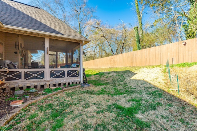 view of yard featuring a sunroom and fence