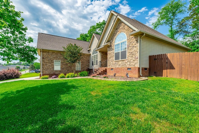 1525 Courtland Dr, Hixson, TN 37343 - view of front of home featuring crawl space, roof with shingles, fence, a front lawn, and stone siding