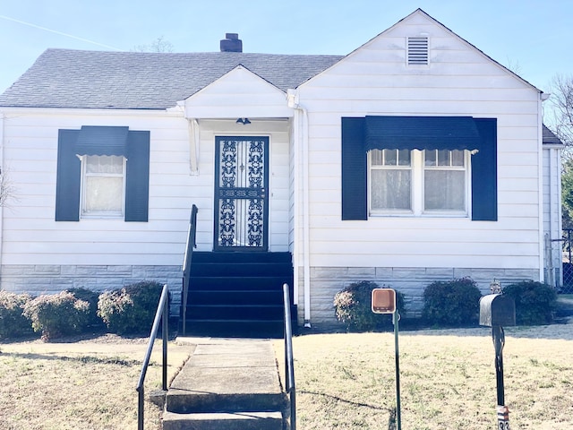 view of front of house with a chimney and roof with shingles