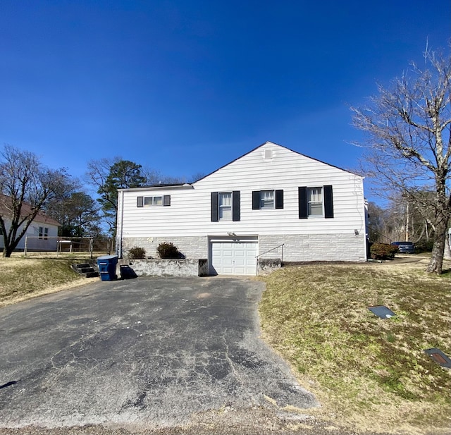 view of front of home with aphalt driveway and an attached garage