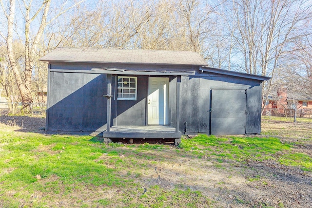 view of outbuilding featuring fence and an outdoor structure