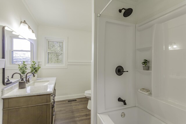 full bathroom featuring toilet, shower / bath combination, wood finished floors, vanity, and visible vents