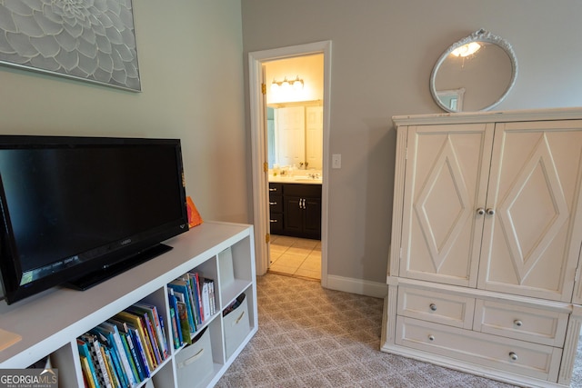 bedroom with light carpet and baseboards