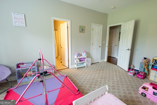 game room featuring baseboards and light colored carpet