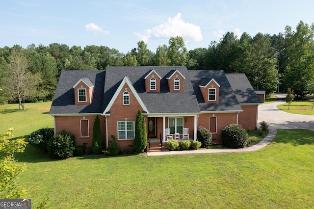 cape cod home featuring crawl space, a front lawn, a porch, and brick siding