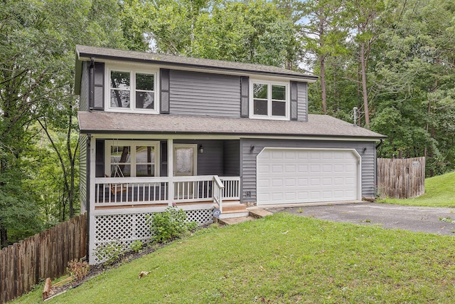 traditional home with a porch, a front yard, fence, and driveway