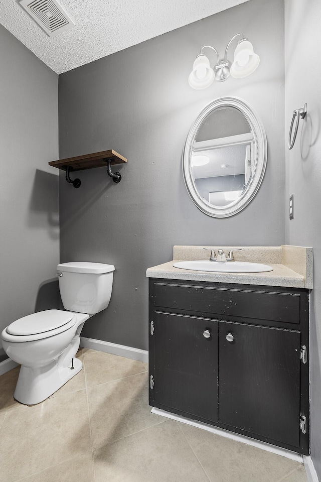 bathroom featuring tile patterned flooring, visible vents, vanity, and toilet