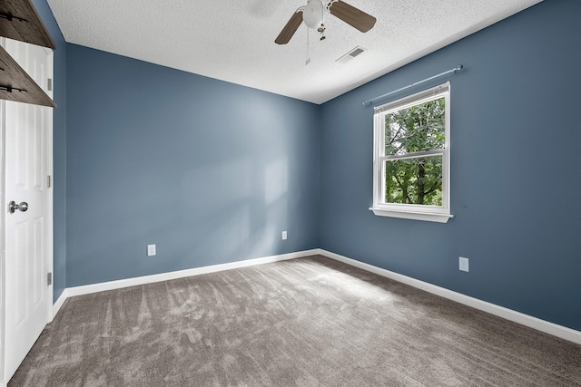 unfurnished room featuring carpet, visible vents, ceiling fan, a textured ceiling, and baseboards