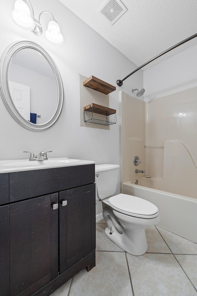 full bath featuring visible vents, toilet, tile patterned flooring, a textured ceiling, and vanity