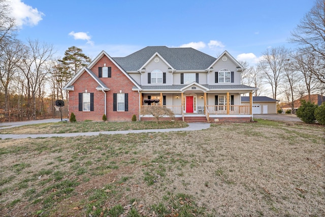 traditional home featuring brick siding, a shingled roof, covered porch, a garage, and a front lawn