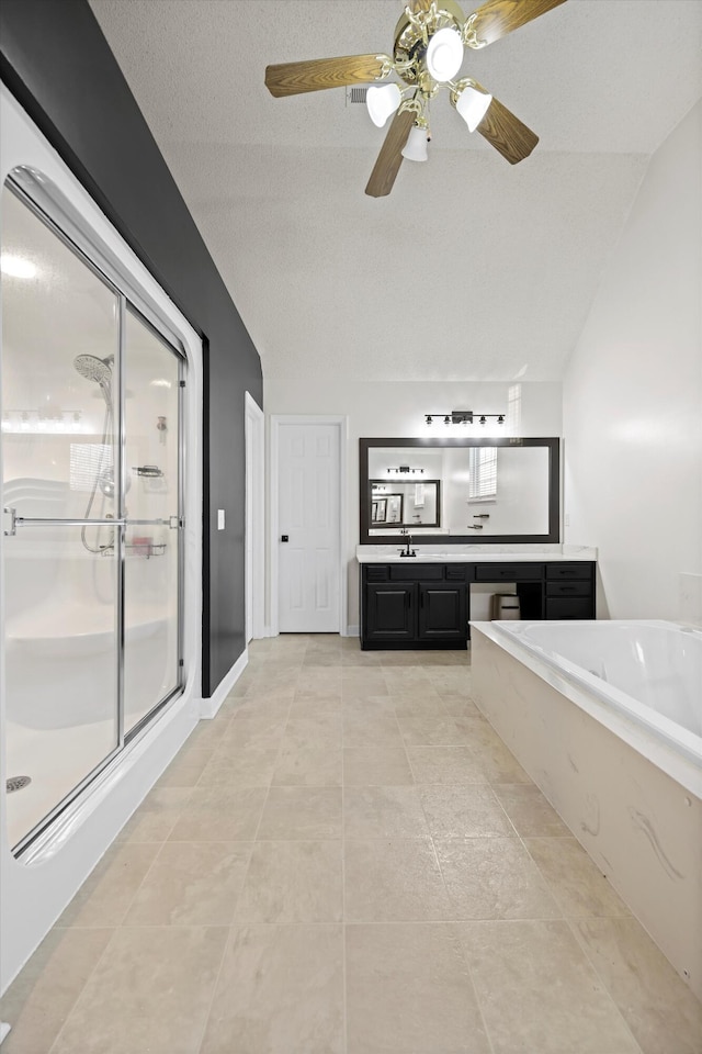 bathroom featuring lofted ceiling, a shower stall, vanity, tile patterned flooring, and a bath