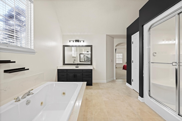 full bathroom with a stall shower, a wealth of natural light, and vanity