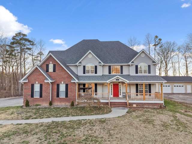 traditional-style home with covered porch, brick siding, roof with shingles, and a front lawn