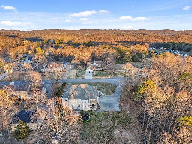 drone / aerial view with a wooded view