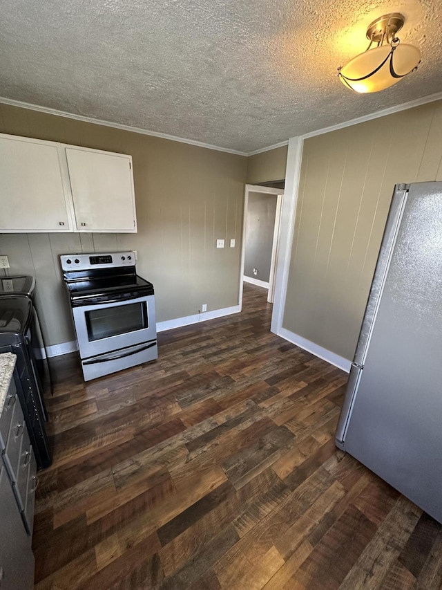 kitchen featuring appliances with stainless steel finishes, washer / clothes dryer, dark wood-style flooring, ornamental molding, and white cabinetry