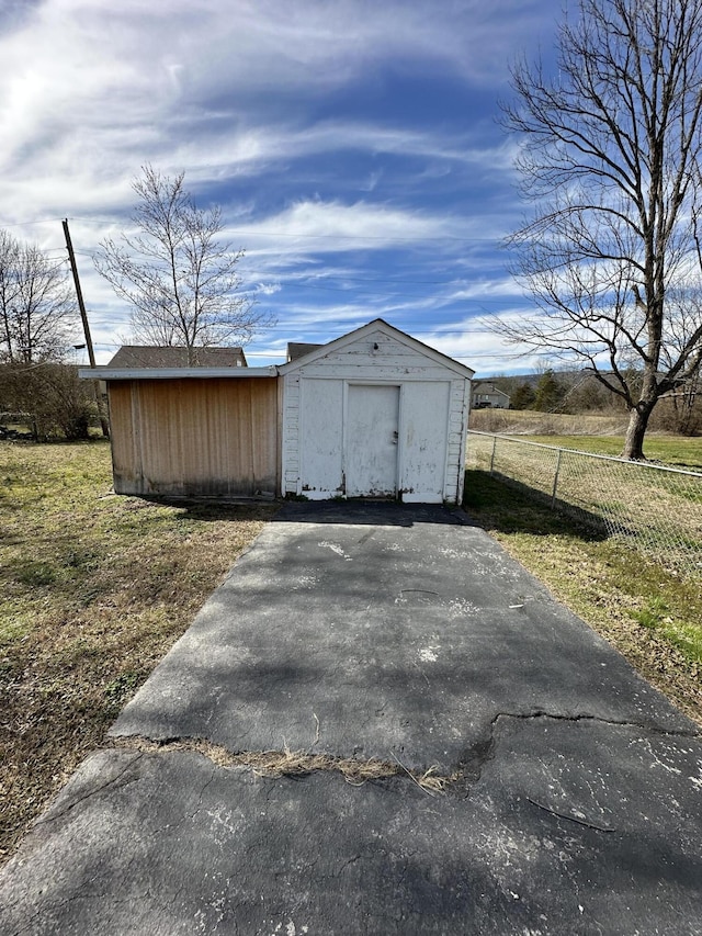 view of shed with fence