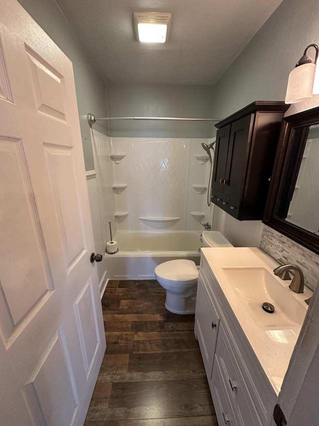 full bathroom with toilet, bathtub / shower combination, wood finished floors, and vanity