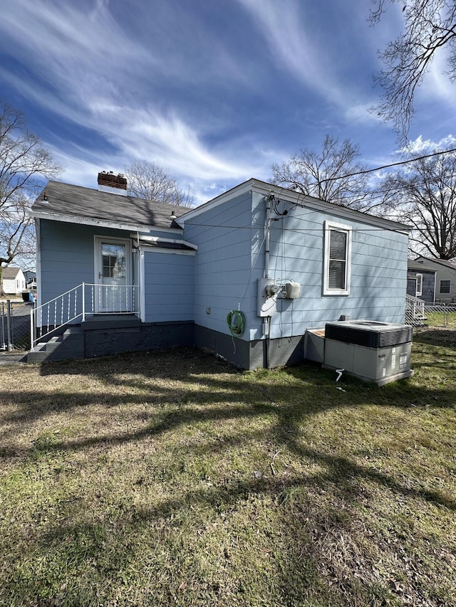 rear view of house with a yard