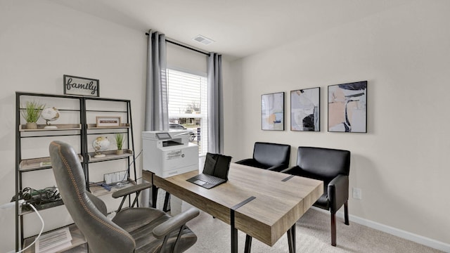 office space with visible vents, baseboards, and light colored carpet