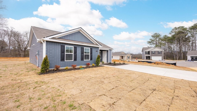 view of front of property with a front yard and driveway