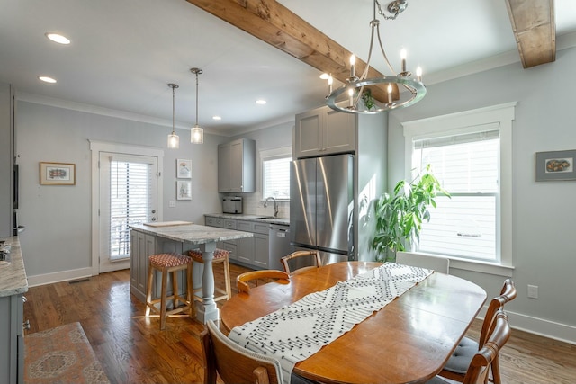 dining room with dark wood-style floors, baseboards, beamed ceiling, and ornamental molding