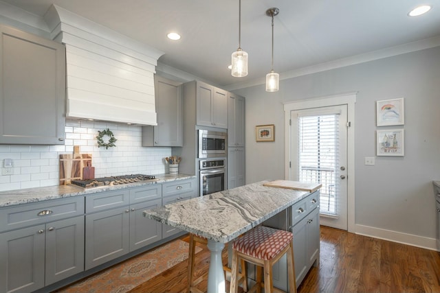 kitchen featuring appliances with stainless steel finishes, gray cabinets, crown molding, and decorative backsplash