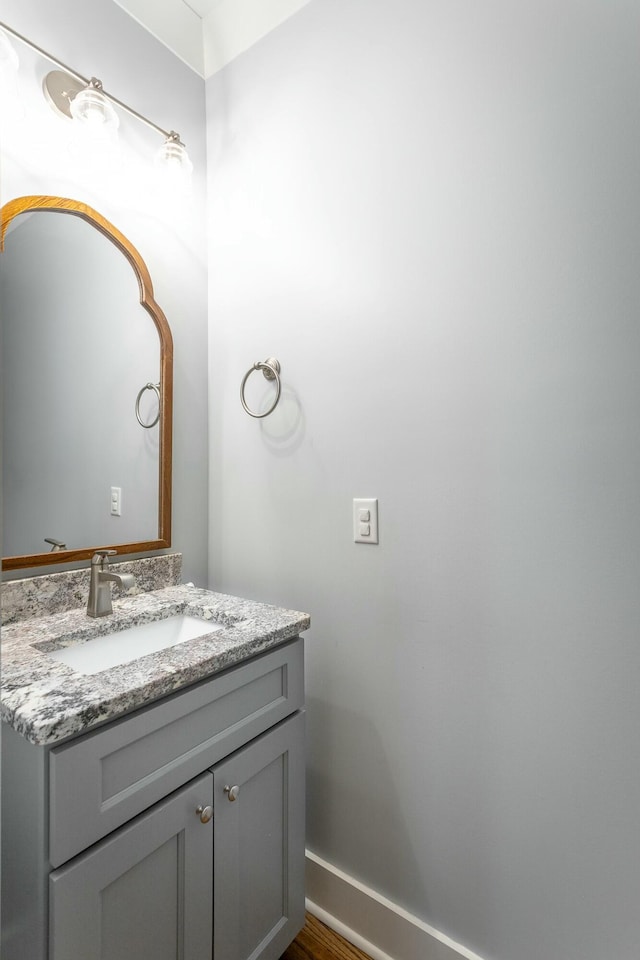 bathroom featuring baseboards and vanity