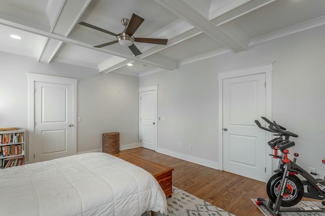 bedroom with beam ceiling, baseboards, coffered ceiling, and wood finished floors