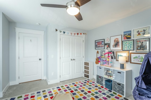 rec room with carpet, baseboards, and ceiling fan