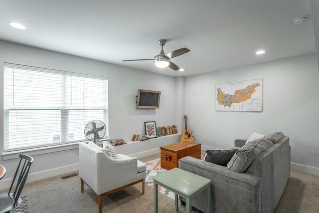 living room with recessed lighting, visible vents, a ceiling fan, light carpet, and baseboards