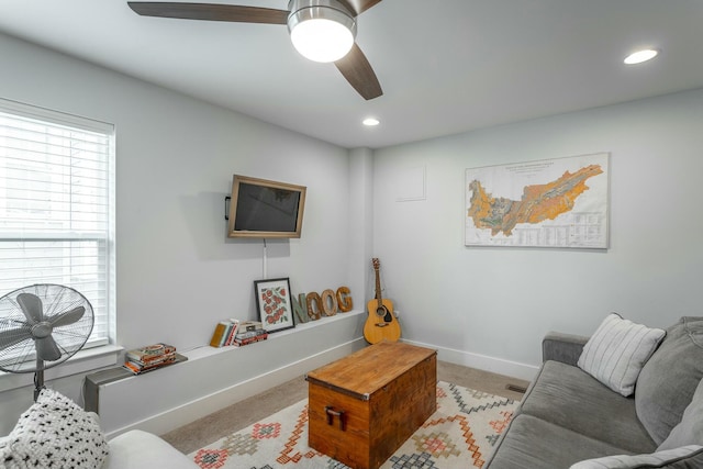 carpeted living area with recessed lighting, ceiling fan, and baseboards