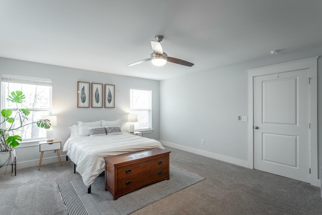 carpeted bedroom featuring a ceiling fan and baseboards